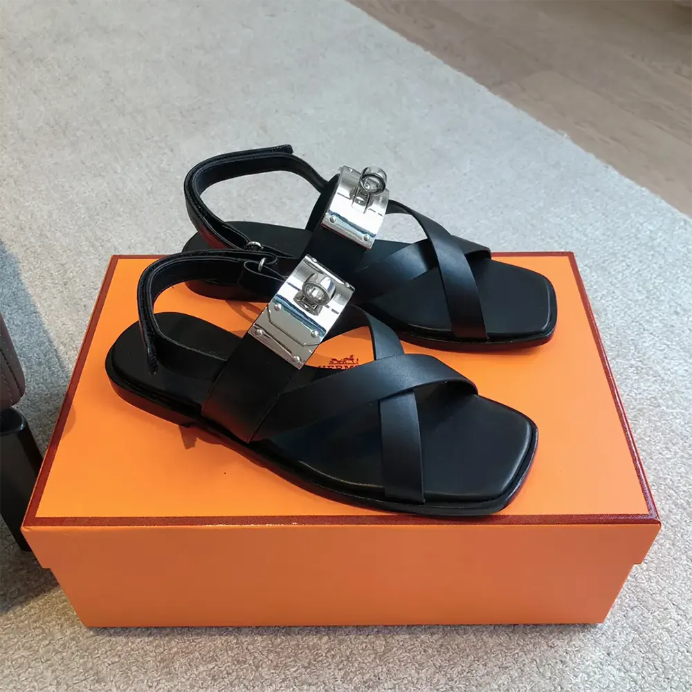 Close-up of Hermes Women Ines Sandal-Black leather and signature hardware