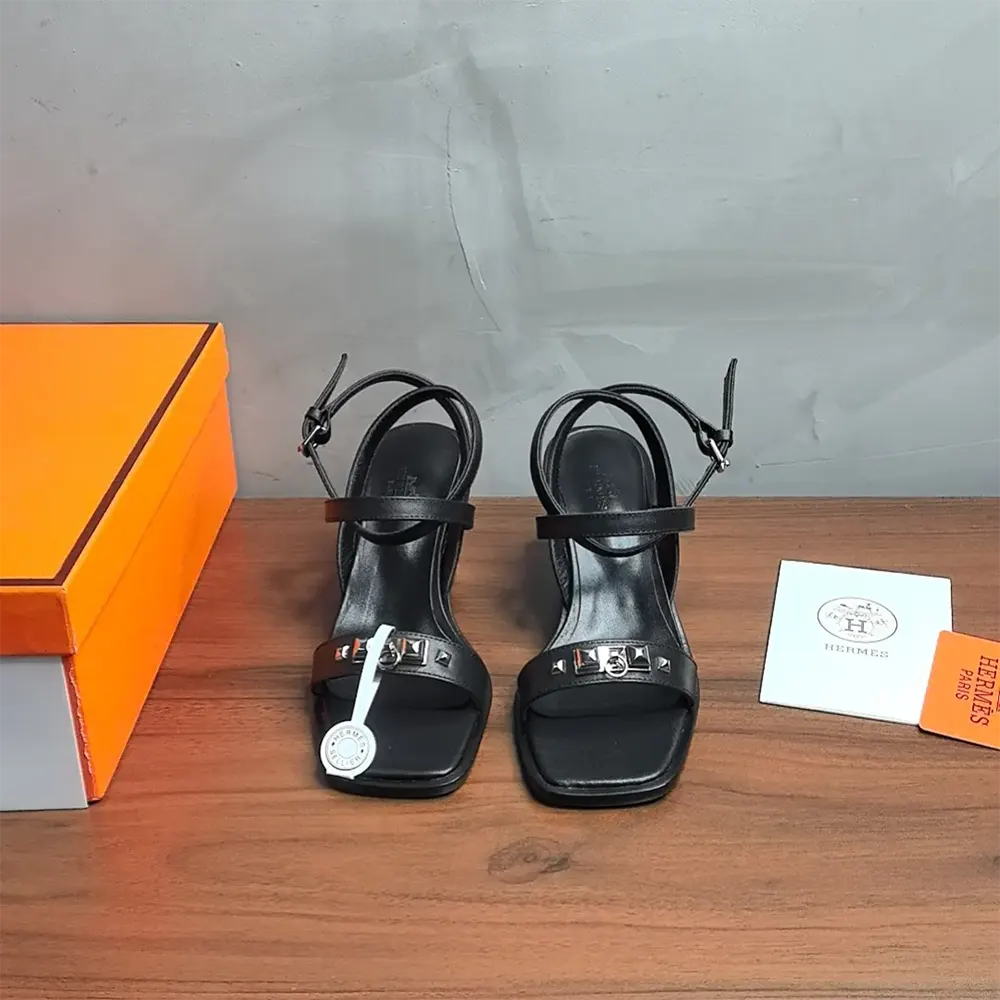 Close-up on black leather and silver buckle of Hermes Women Ivresse 65 Sandal-Black