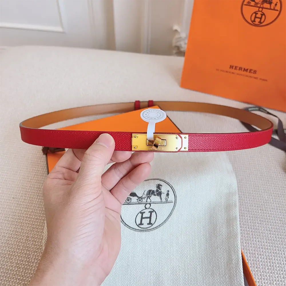 Close-up detailing of Hermes Women Kelly 18 Belt-Red buckle and leather texture