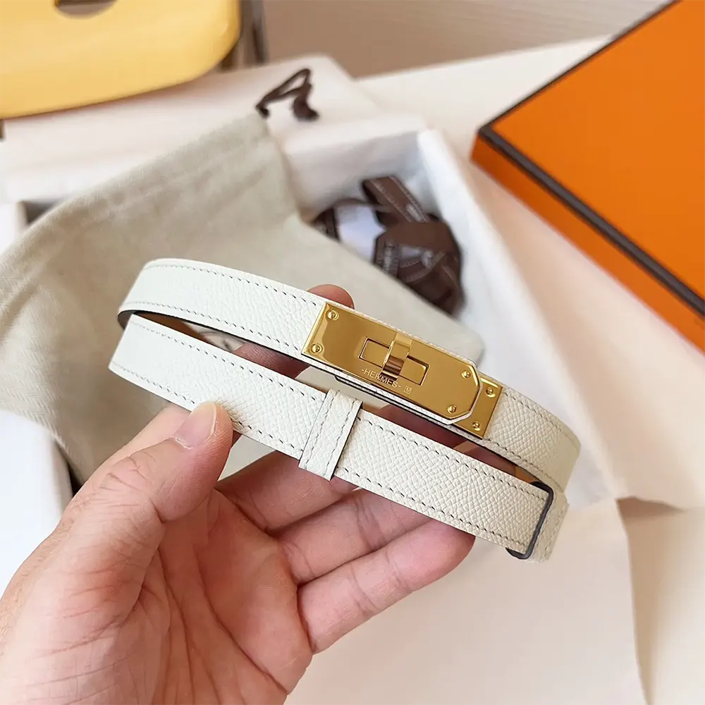 Side angle highlighting smooth leather and hardware of Hermes Women Kelly 18 Belt-White