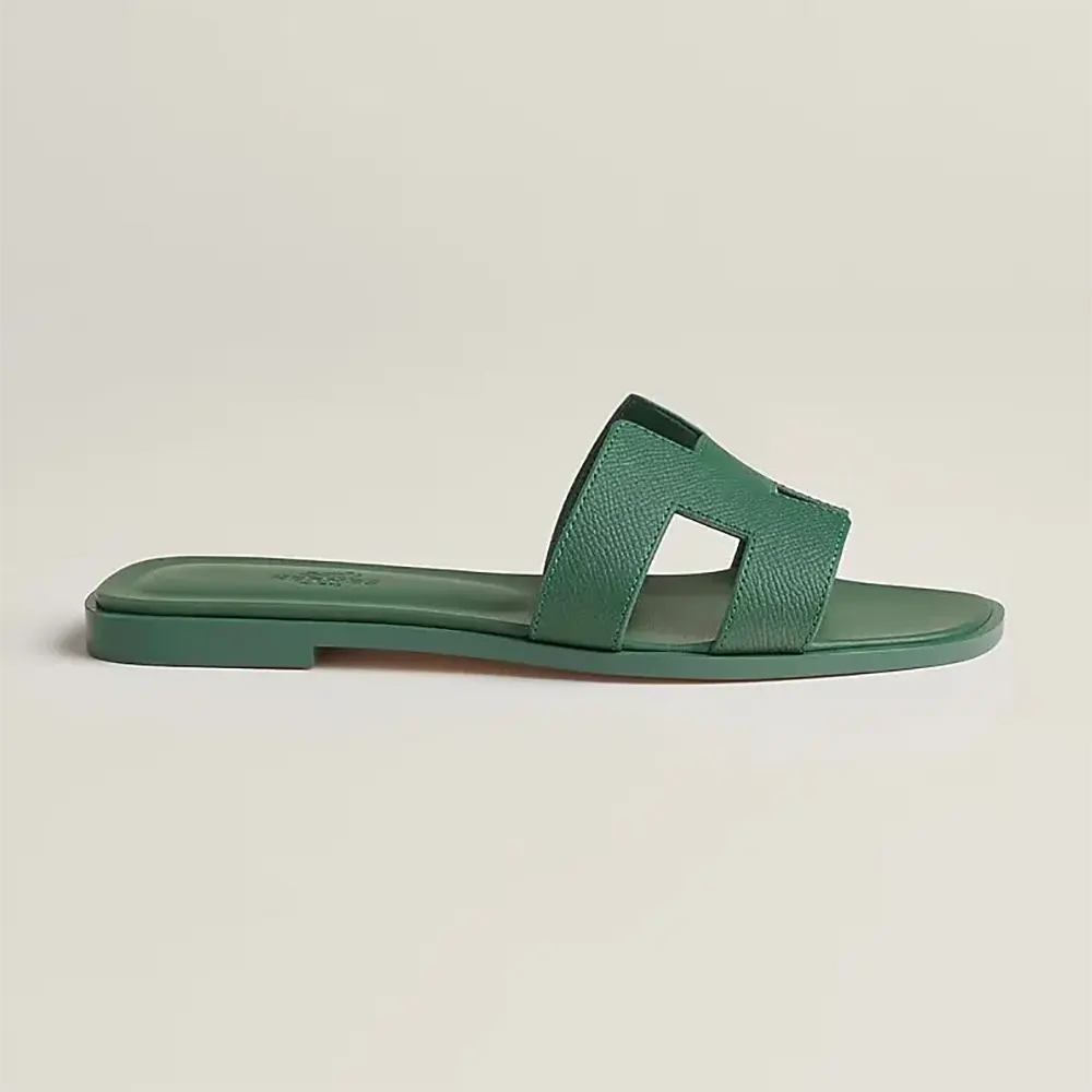 Side angle of Hermes Women Oran Sandal-Green showcasing the green calfskin