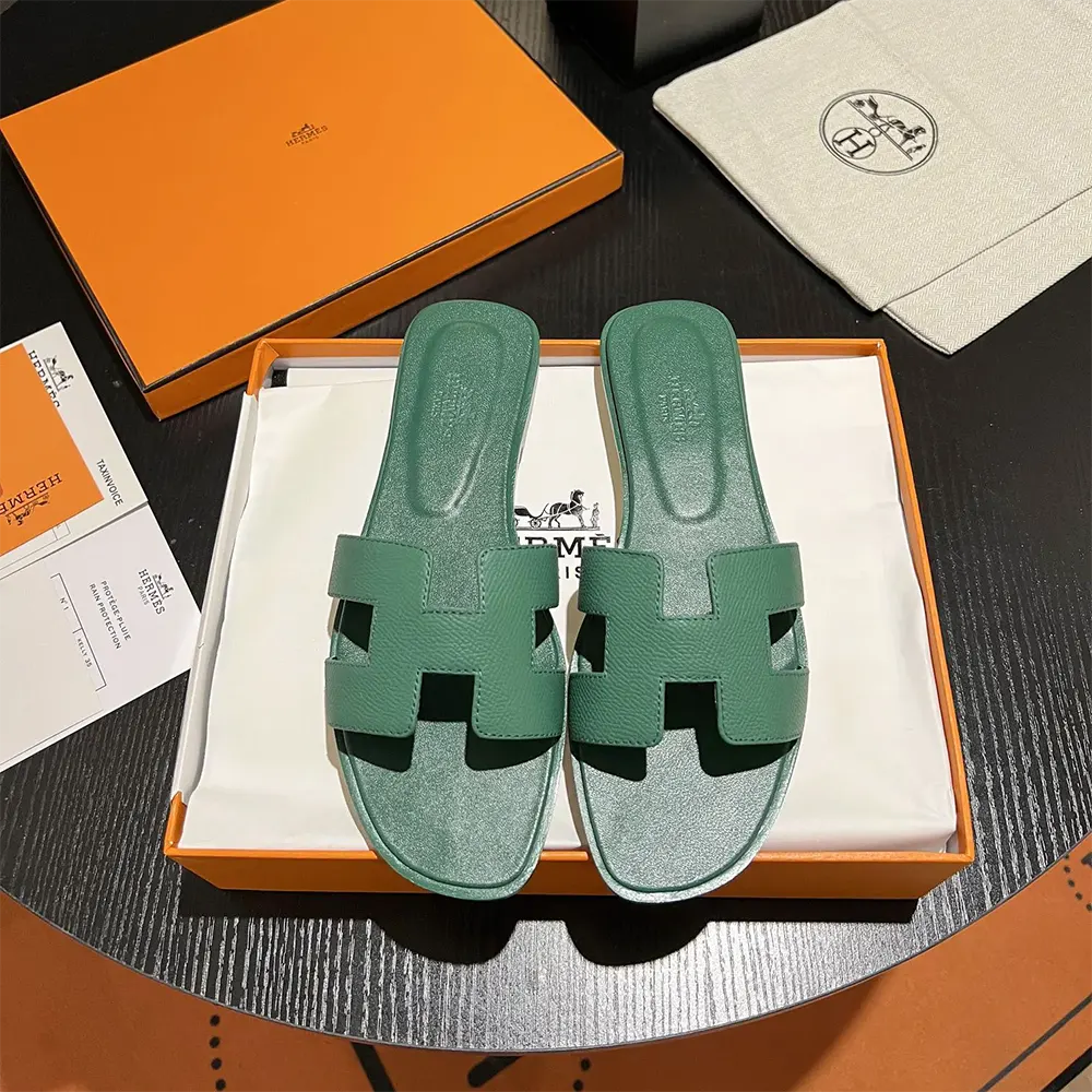 Close-up of signature H cutout detail on Hermes Women Oran Sandal-Green