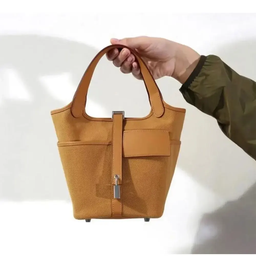 Side angle showing leather trim and canvas texture of Hermes Women Picotin Lock handbag