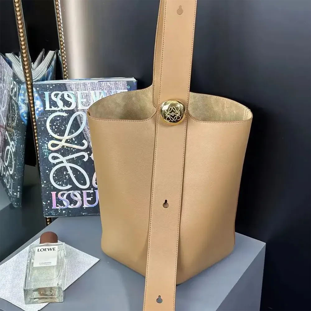 Close-up on pebble leather texture and silver hardware of Loewe bucket bag