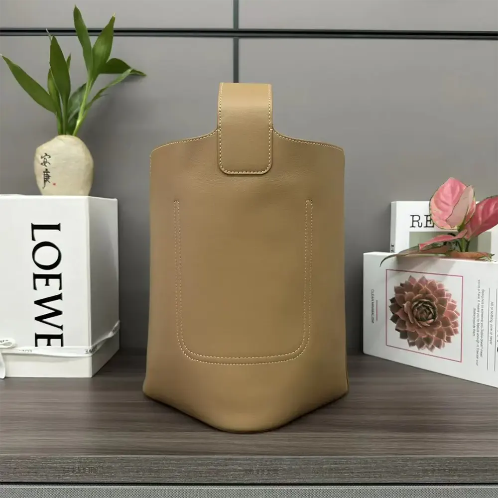 Side profile showing soft grained calfskin texture on Loewe Unisex Mini Pebble Bucket Bag