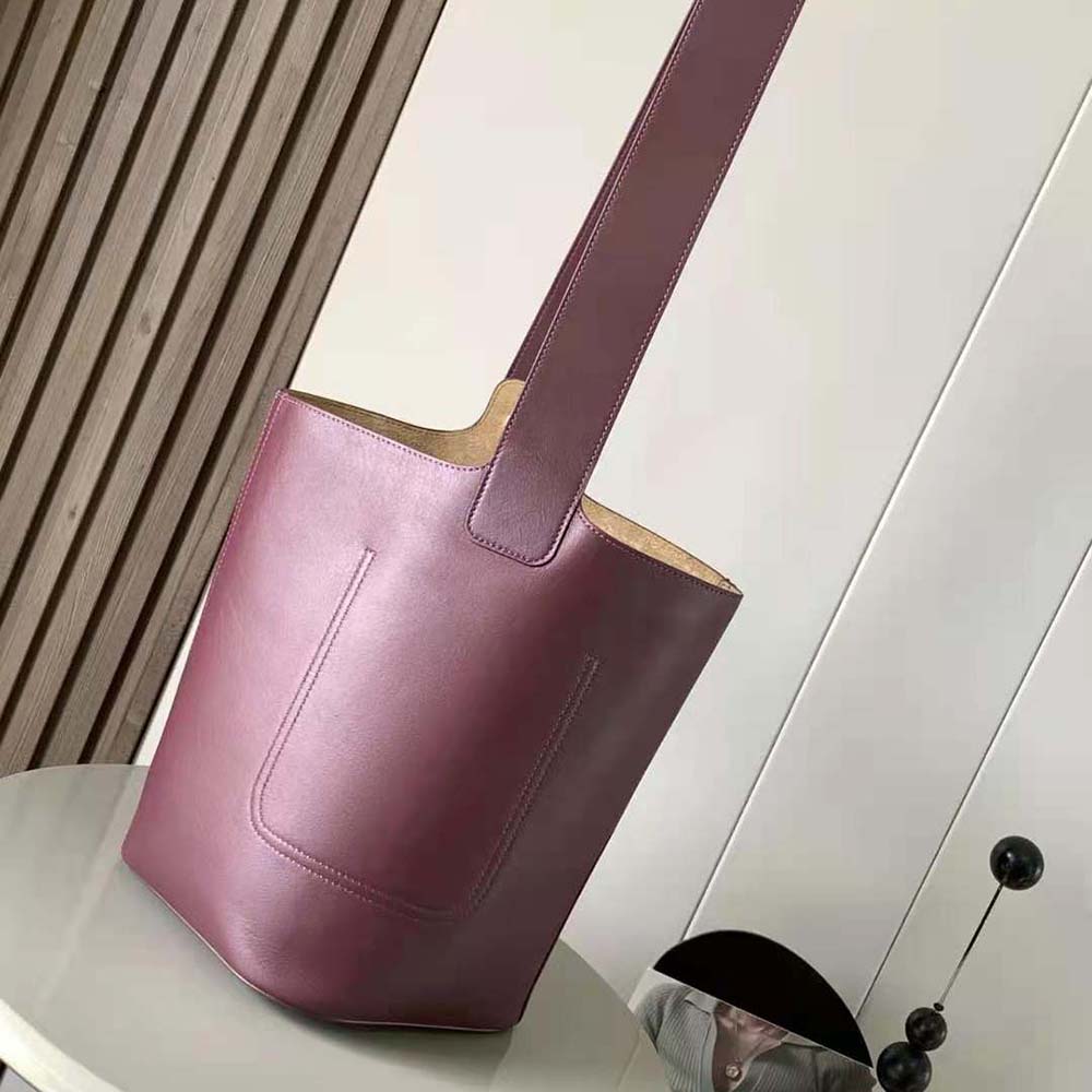 Side profile showing drawstring closure and polished hardware on Loewe bag