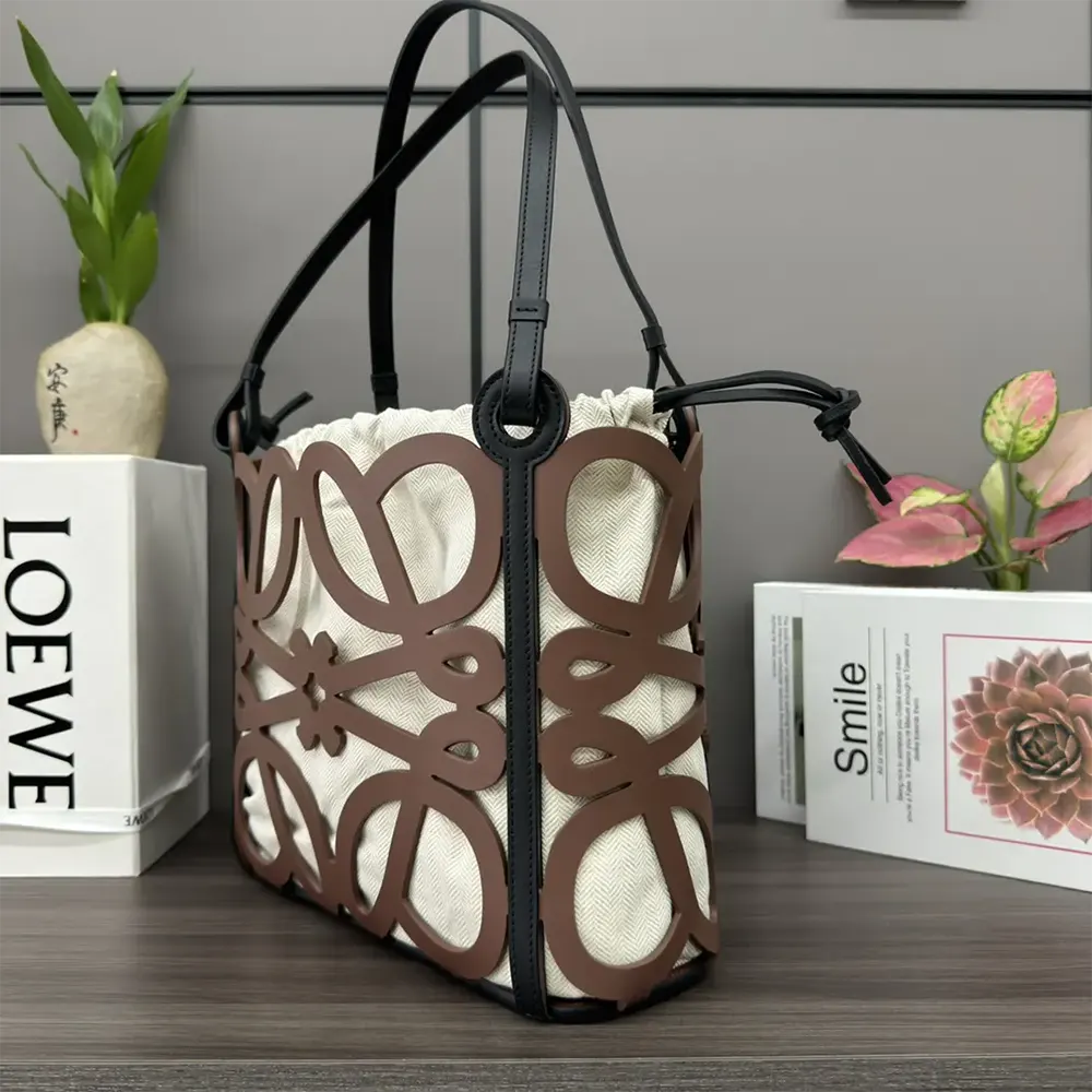 Side view showing structured silhouette of Loewe Women Small Anagram Cut-out Tote