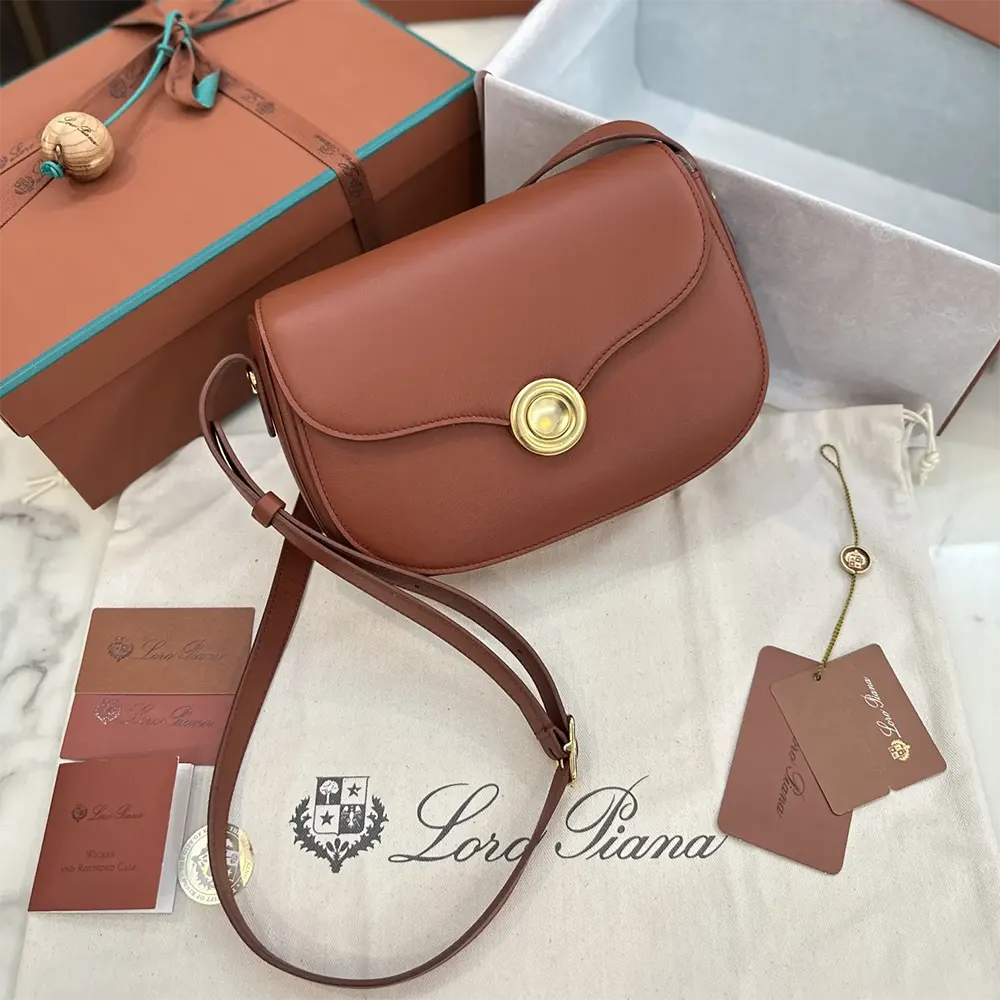 Side angle highlighting compact silhouette of Loro Piana Women Mini Ghiera Bag-Brown