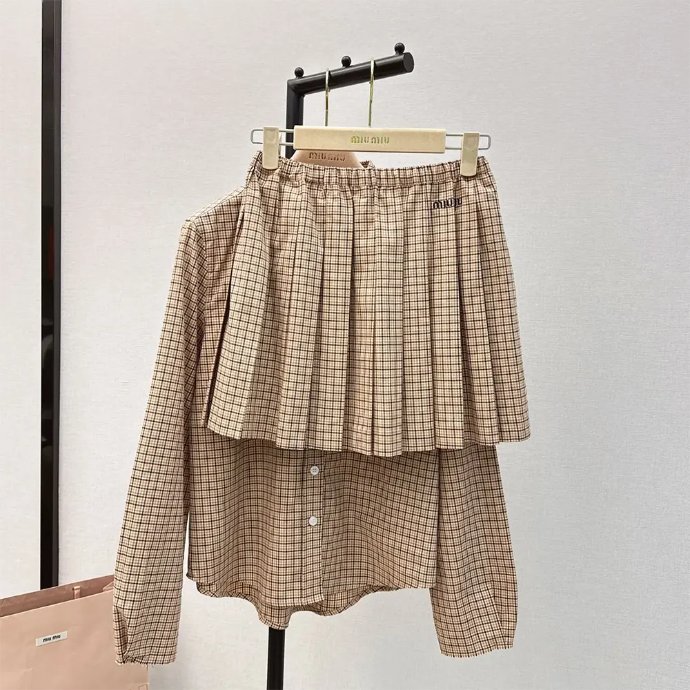 Close-up of embroidered logo detail on Miu Miu checked miniskirt