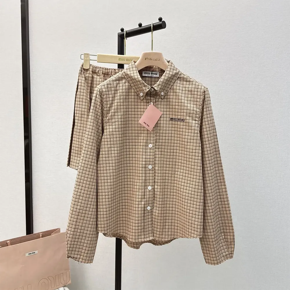 Close-up of embroidered logo on Miu Miu Women Checked Shirt brown fabric