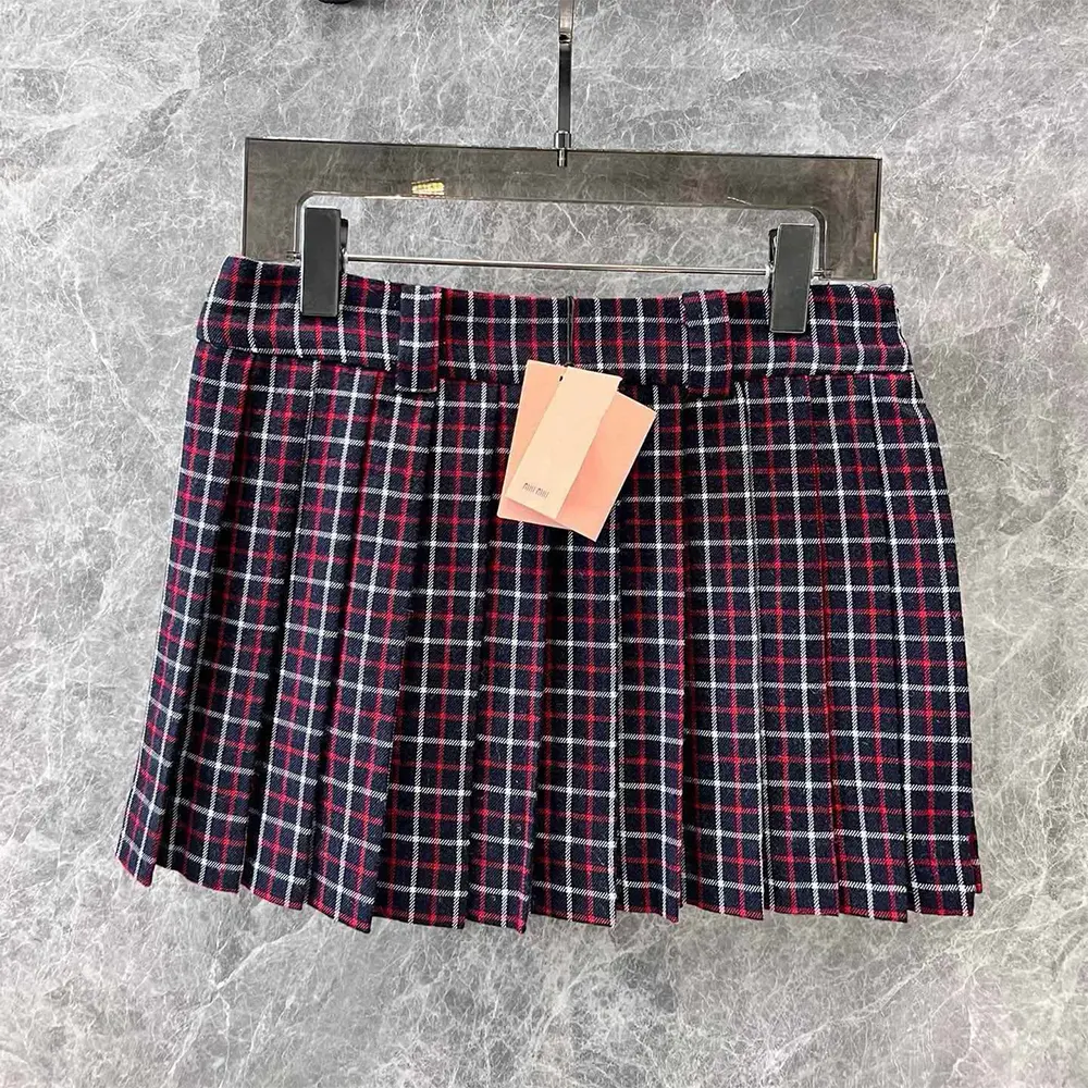Close-up detail of checked wool fabric on Miu Miu miniskirt
