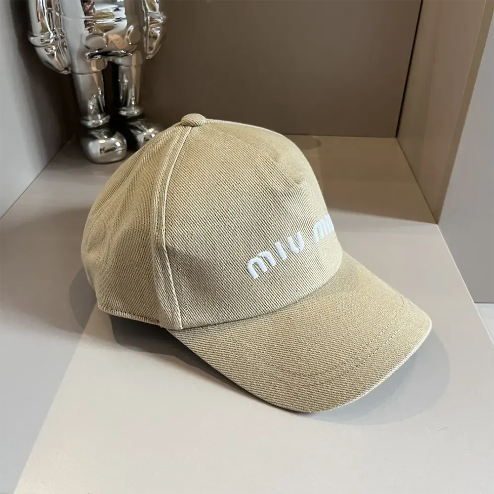 Close-up of silver-tone logo hardware on Miu Miu Women Drill Baseball Cap-Beige