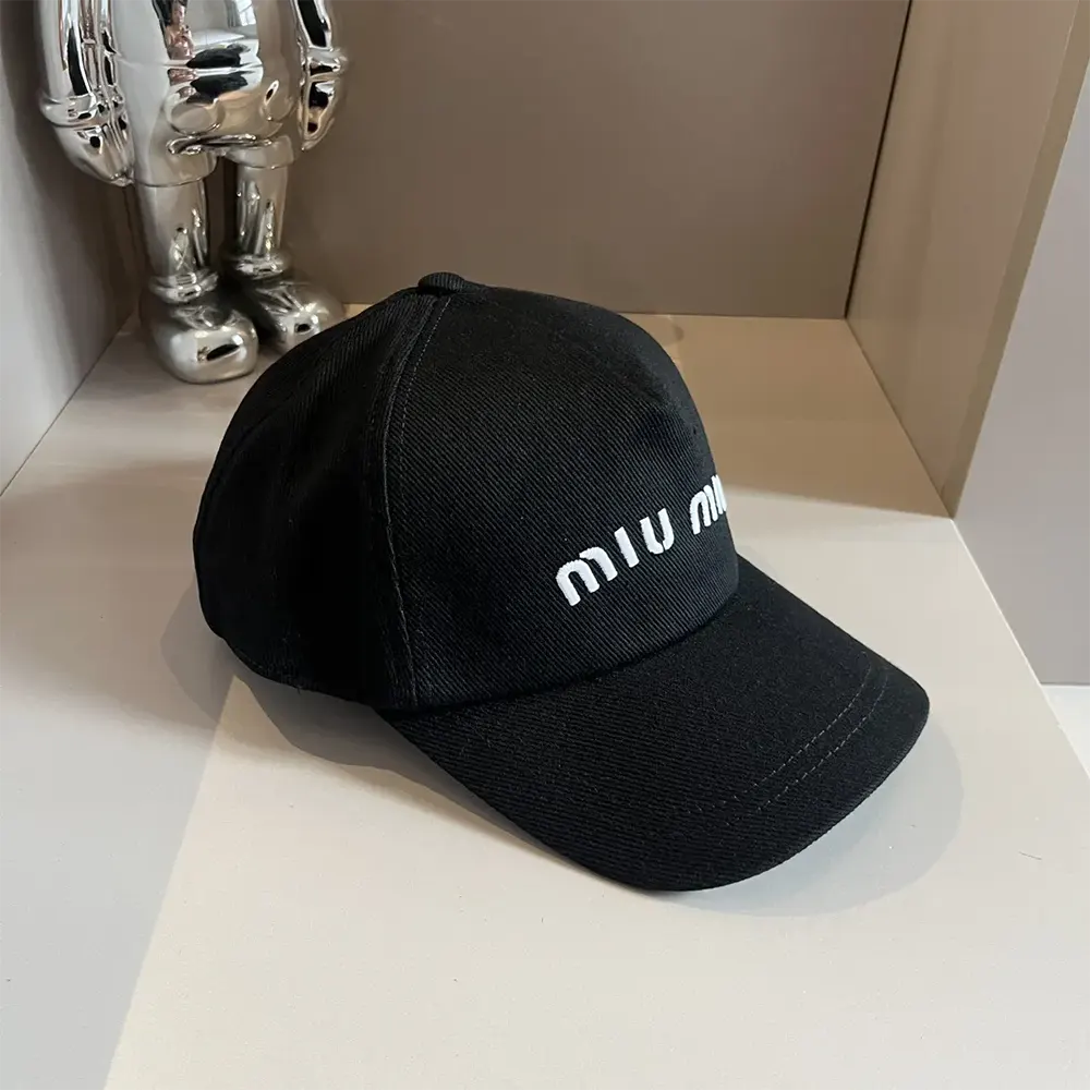 Close-up detail of metal logo hardware on Miu Miu Women Drill Baseball Cap-Black