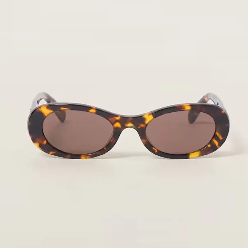 Close-up of gold-tone logo on Miu Miu Women Miu Glimpse Sunglasses