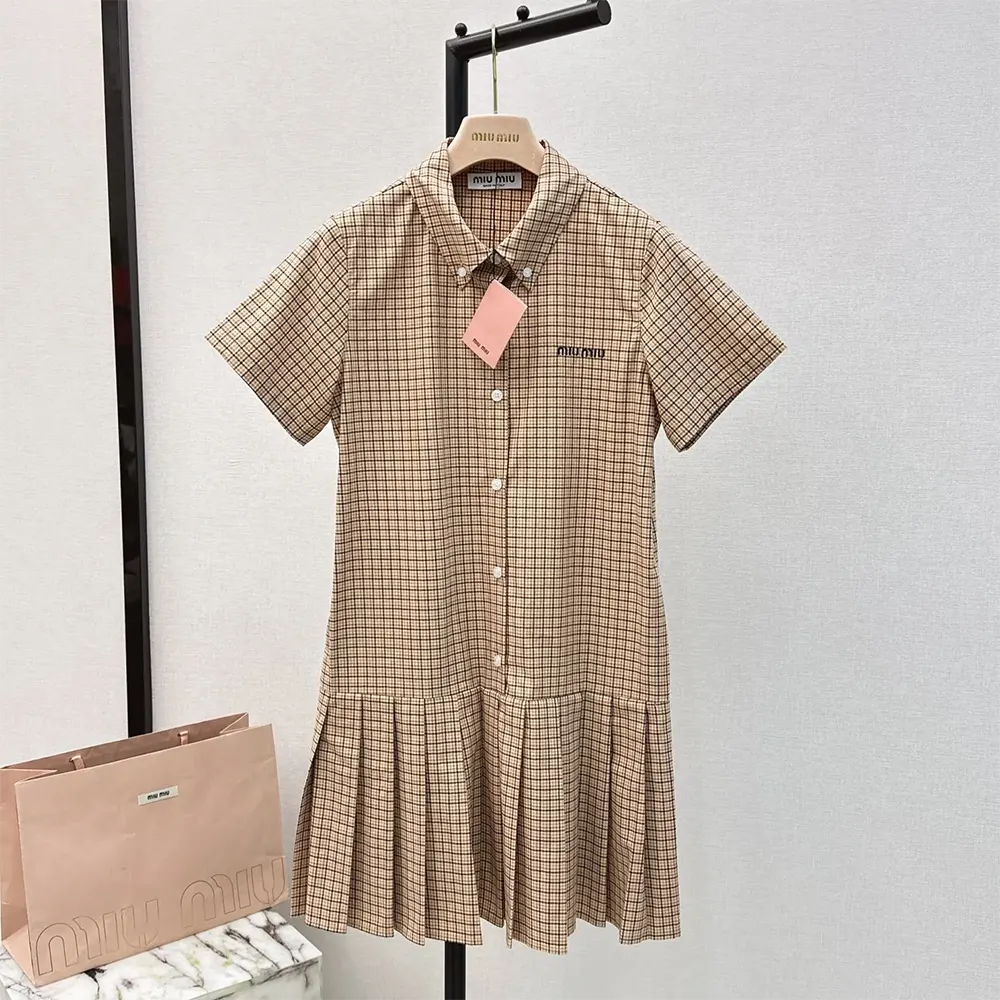Close-up detail of embroidered logo on Miu Miu Women Pleated Check Dress