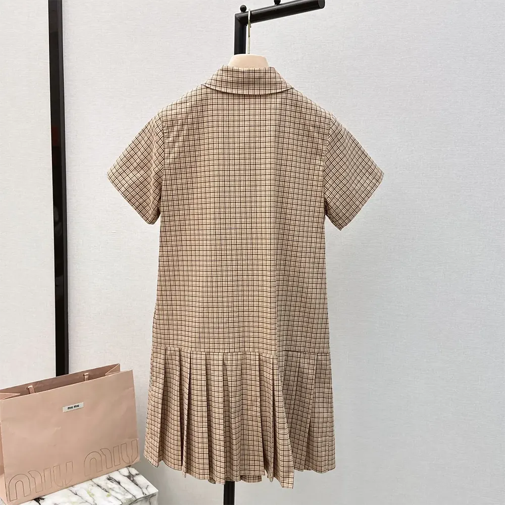 Side angle showing pleated silhouette of Miu Miu Women Pleated Check Dress