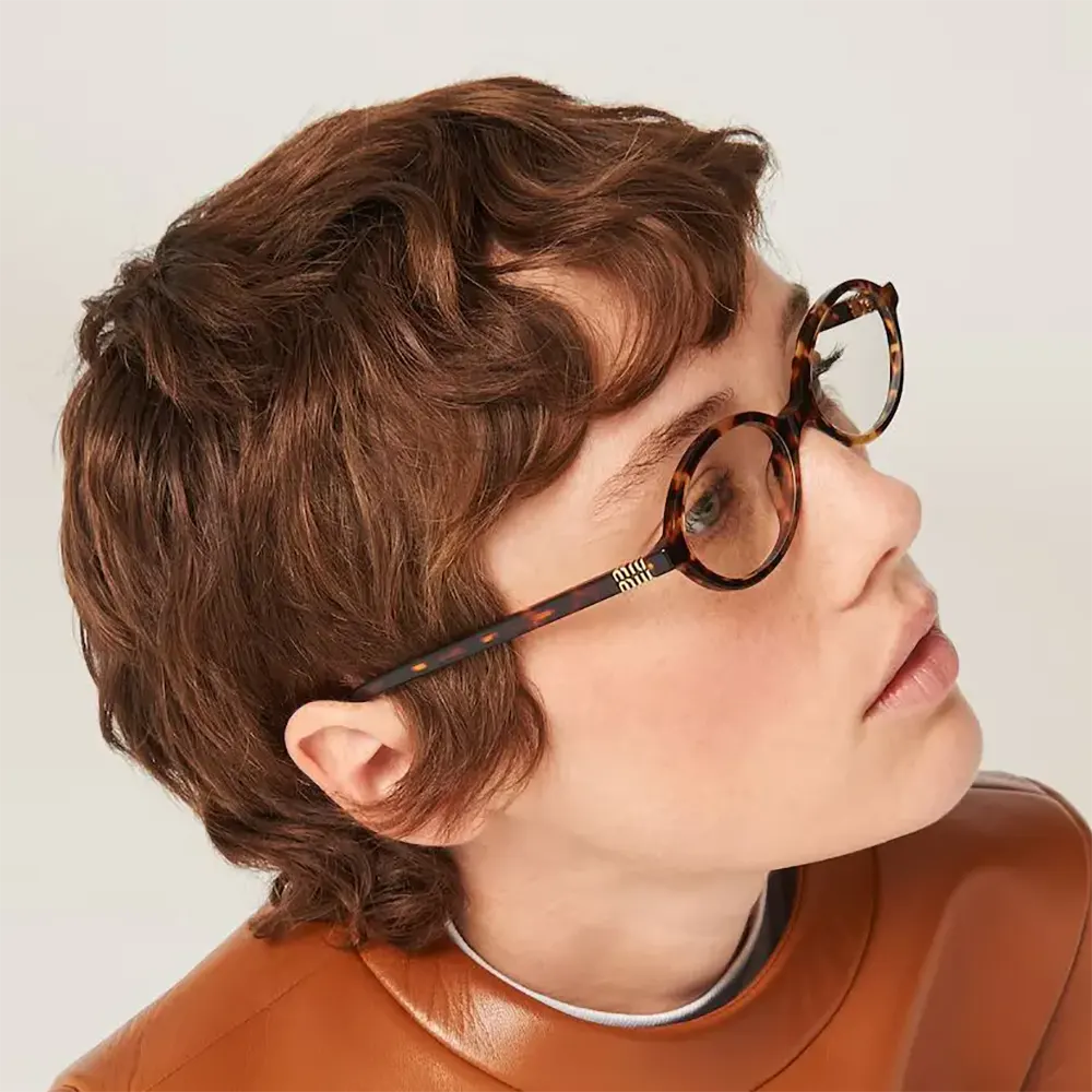 Angled side shot showcasing brown frames of Miu Miu Women Regard Sunglasses