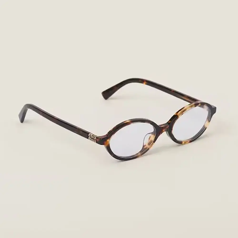 Close-up of silver-tone hardware on Miu Miu Women Regard Sunglasses temple