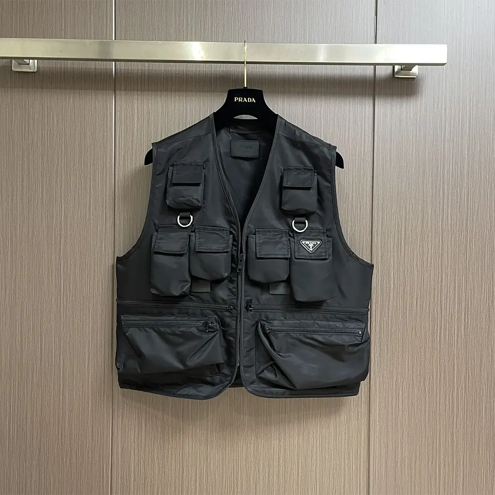 Close-up of Prada logo plaque on black Re Nylon vest