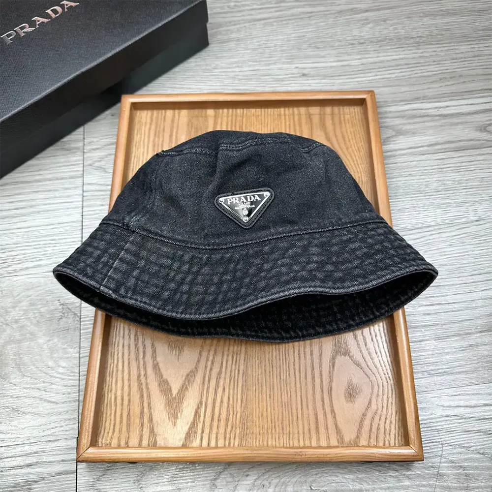 Side angle showcasing shape of Prada Unisex Denim Bucket Hat-Black