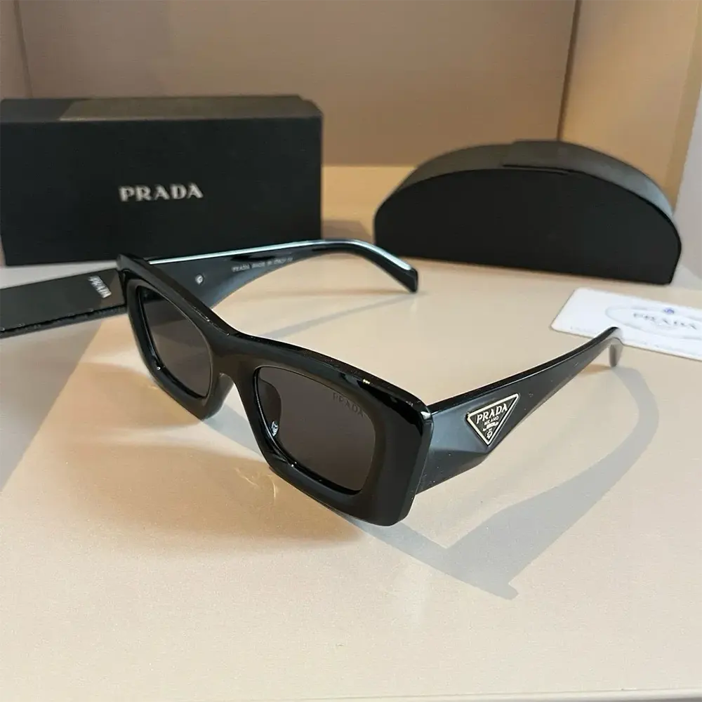 Side angle showing sleek silhouette of Prada Unisex Sunglasses