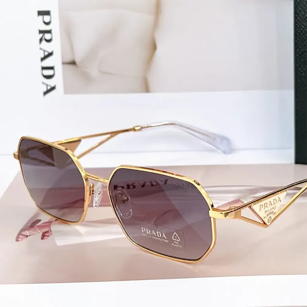 Side angle showing silhouette of Prada Unisex Sunglasses gold frame