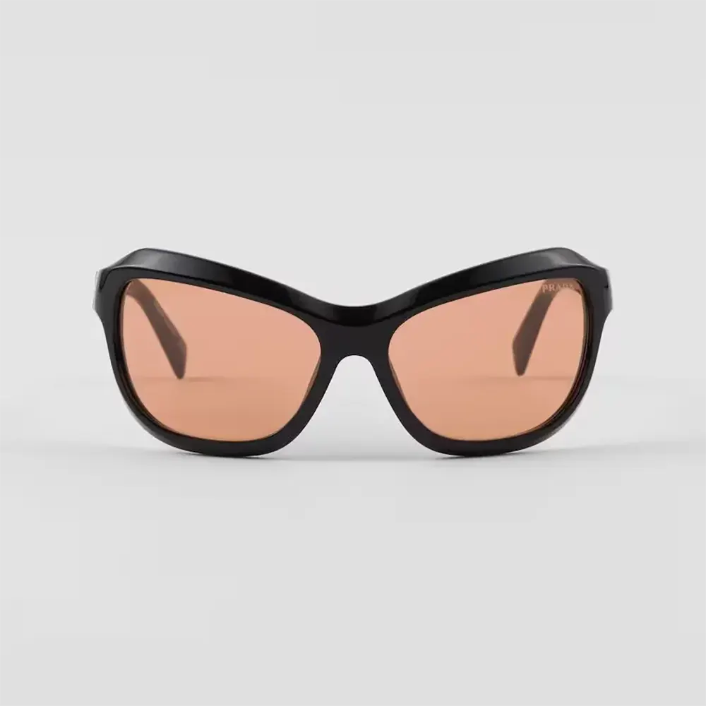 Close-up on signature metal hardware of Prada Unisex Swing Sunglasses