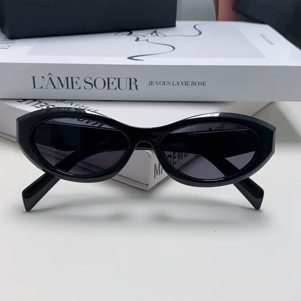 Close-up of Prada logo metal detail on black Symbole Sunglasses