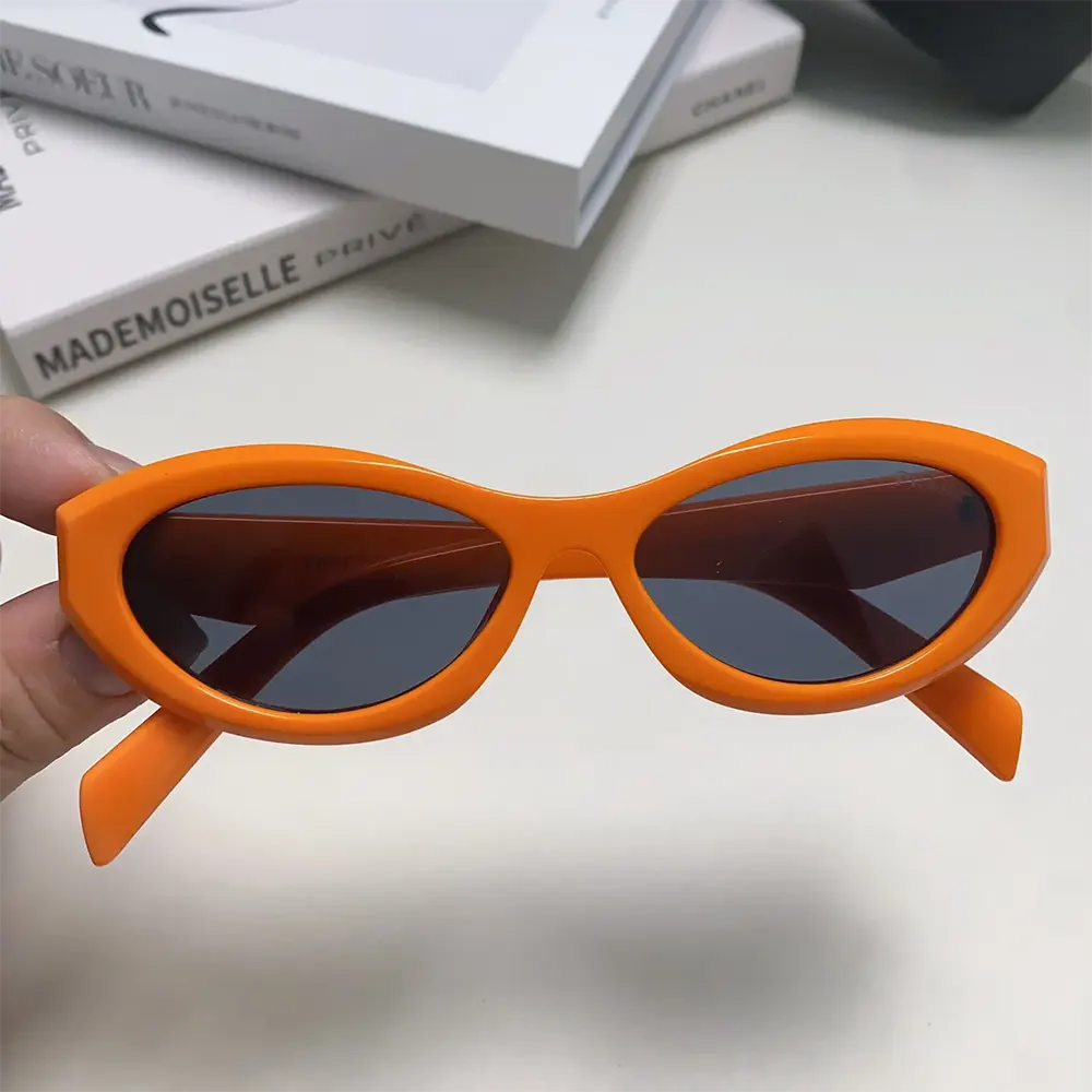 Close-up on silver double bridge detail of Prada Unisex Symbole Sunglasses-Orange