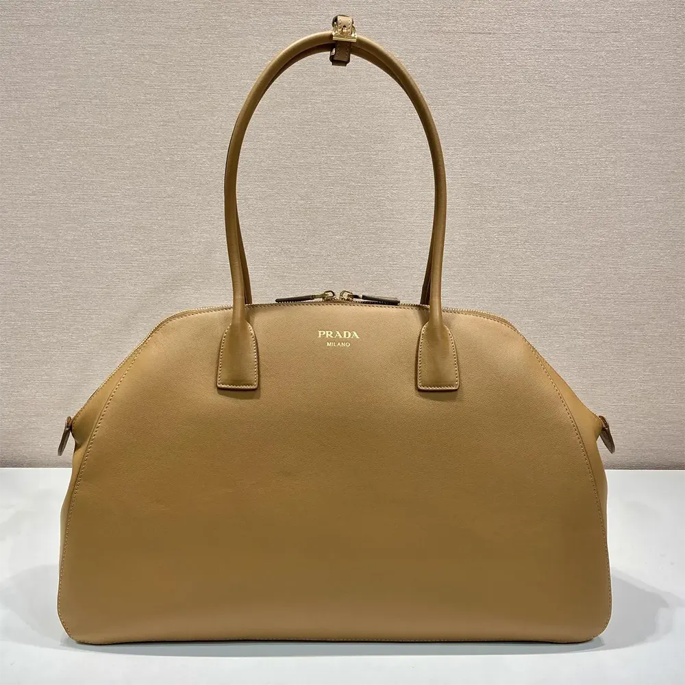 Close-up of brown leather texture and zipper on Prada tote bag