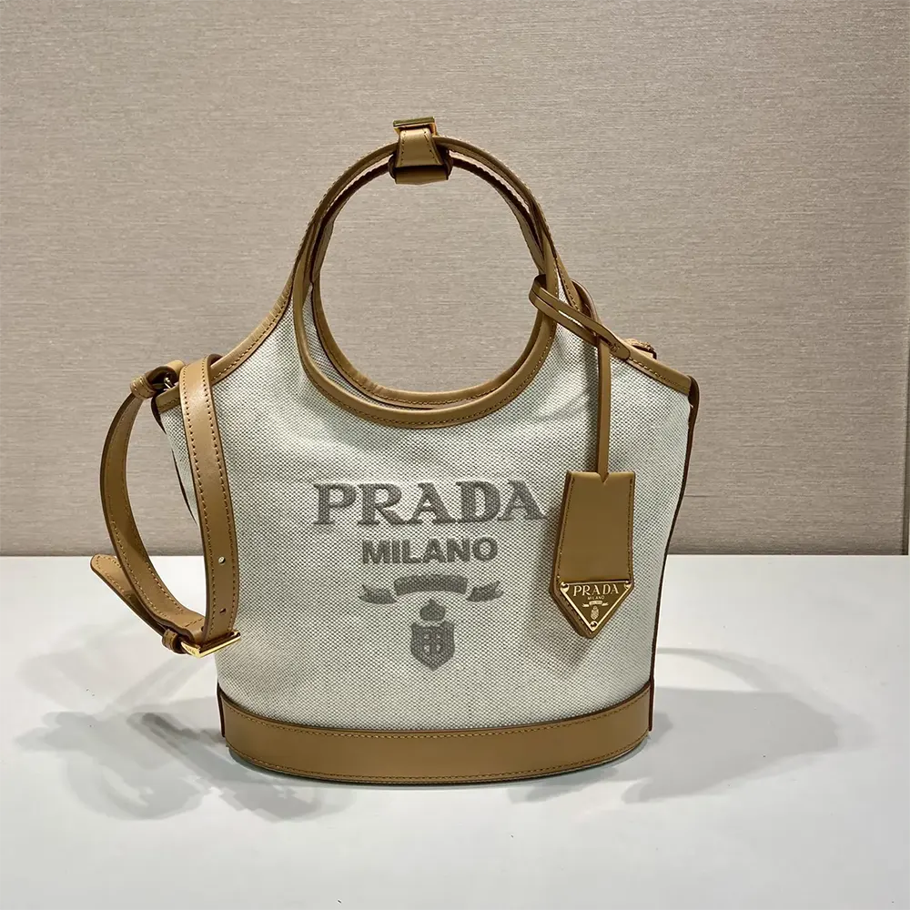 Close-up of gold-tone hardware on Prada Women Medium Linen Blend and Leather Tote Bag