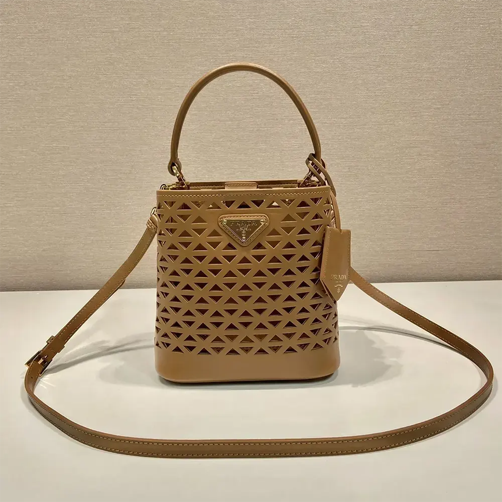 Side angle showing structured silhouette of Prada Women Panier Leather Mini-bag