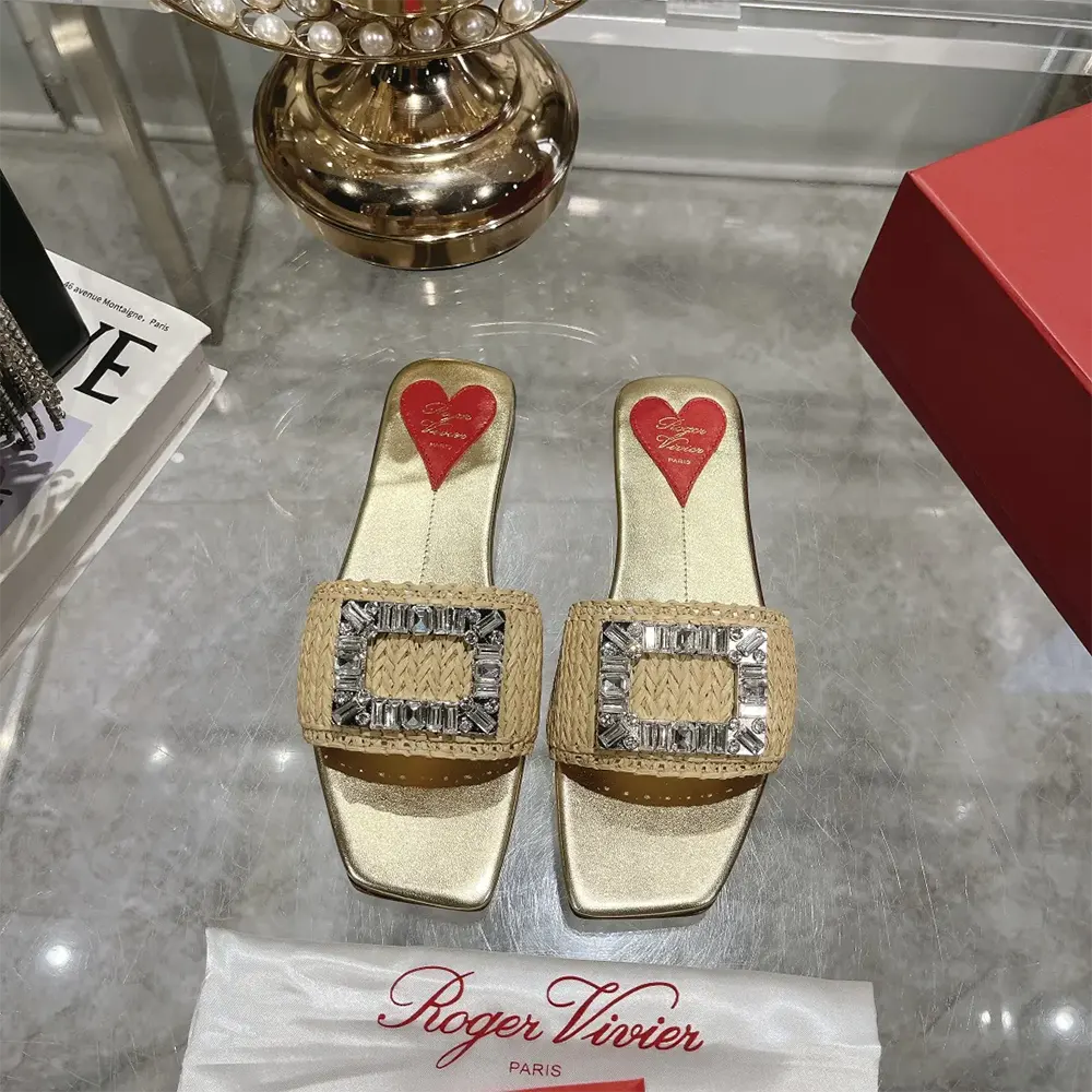 Close-up of sparkling strass buckle on Roger Vivier raffia slides