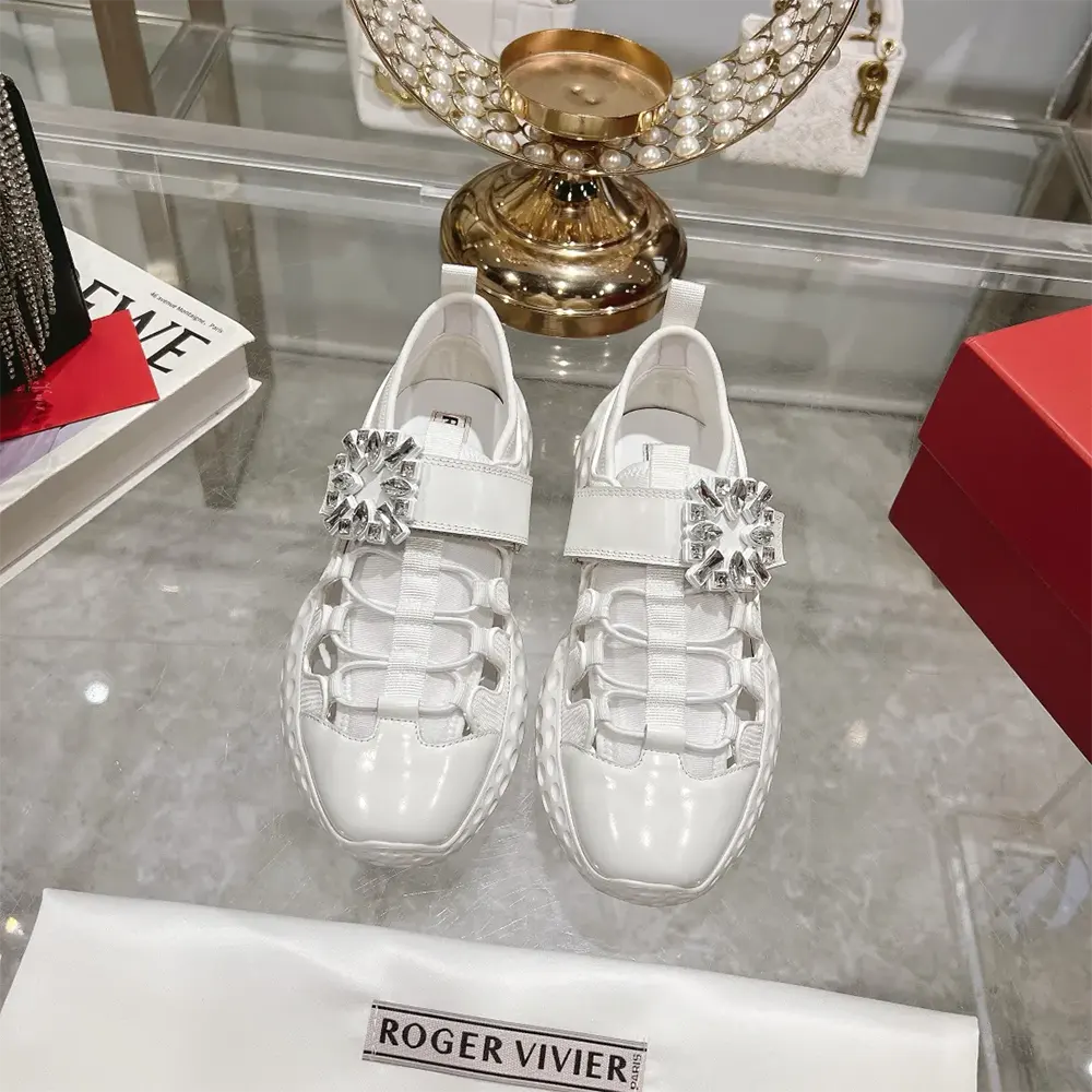 Top view showing white fabric and lace closure of Roger Vivier sneakers