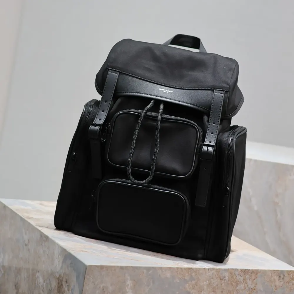 Side angle showing zippered compartments of Saint Laurent backpack