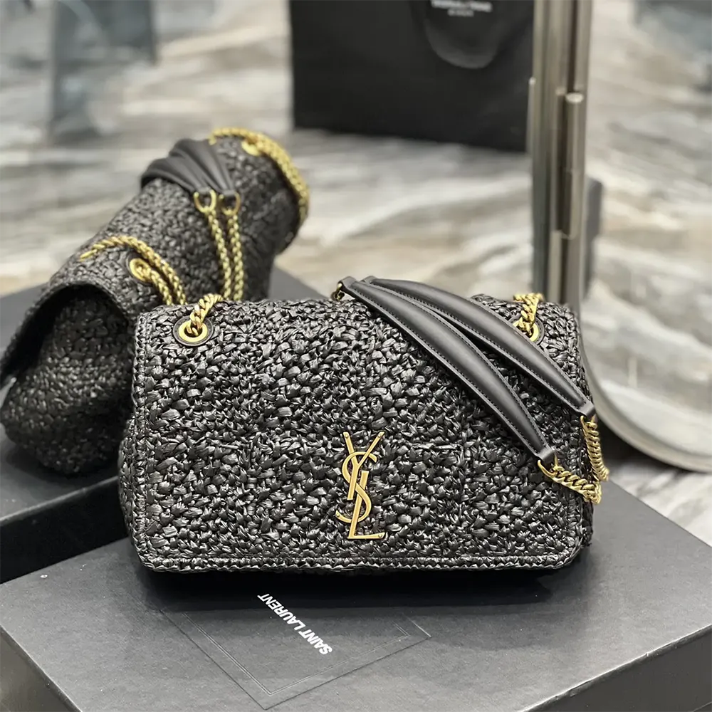 Close-up of gold YSL monogram hardware on Jamie Medium Raffia-Black bag