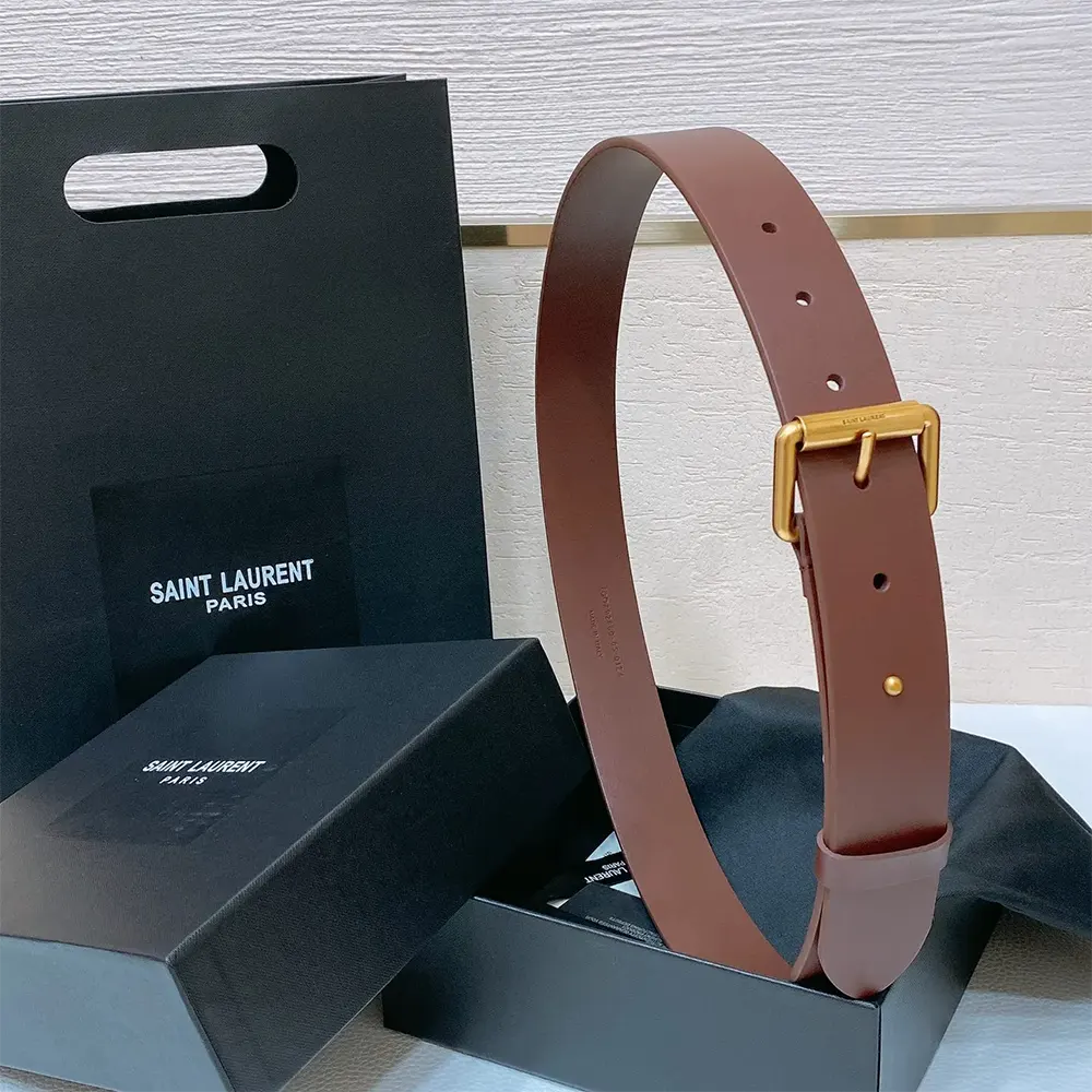 Close-up of silver YSL buckle on brown leather Saint Laurent belt