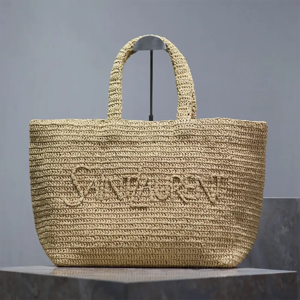 Close-up of natural raffia weave and YSL gold closure on Saint Laurent tote