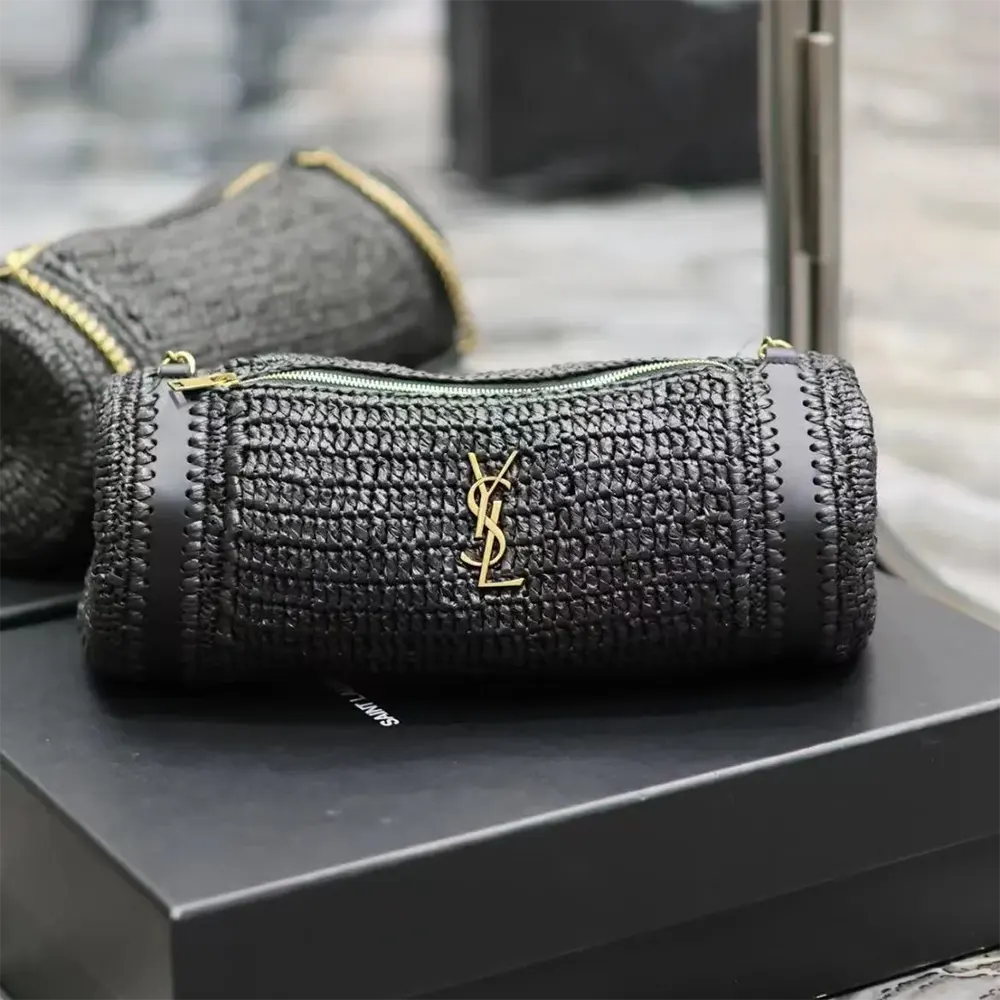 Close-up of gold YSL monogram hardware on cassandre small cylinder bag