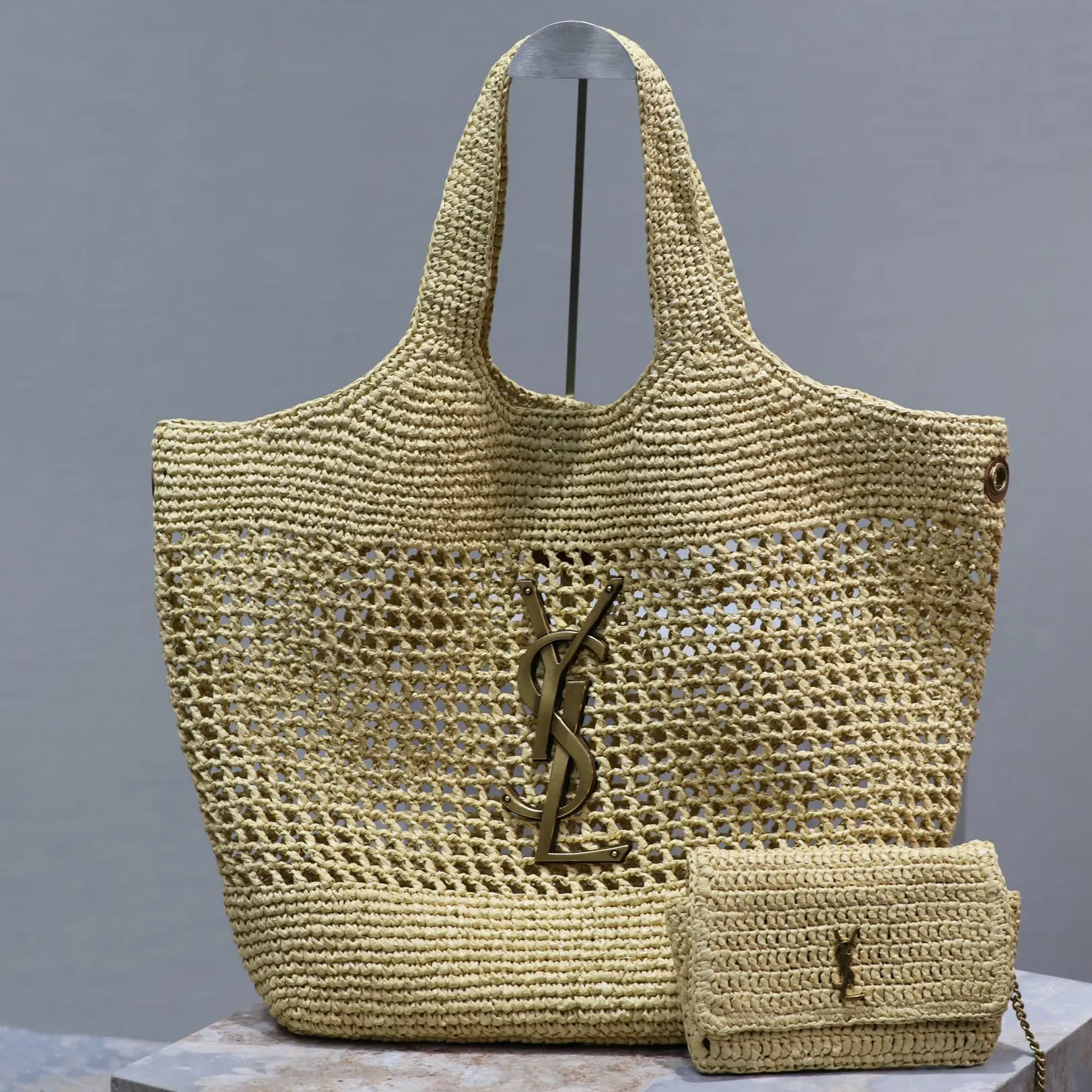 Close-up of gold YSL hardware on Saint Laurent YSL Women Icare in Raffia