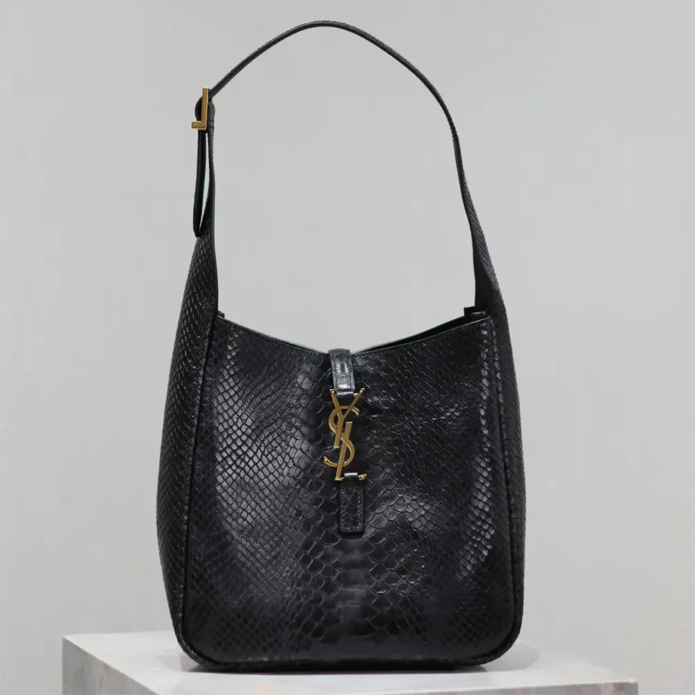 Close-up of gold YSL logo hardware on python leather bag
