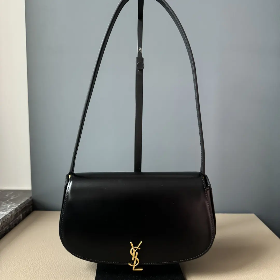 Close-up of gold YSL logo hardware on Mini Voltaire bag