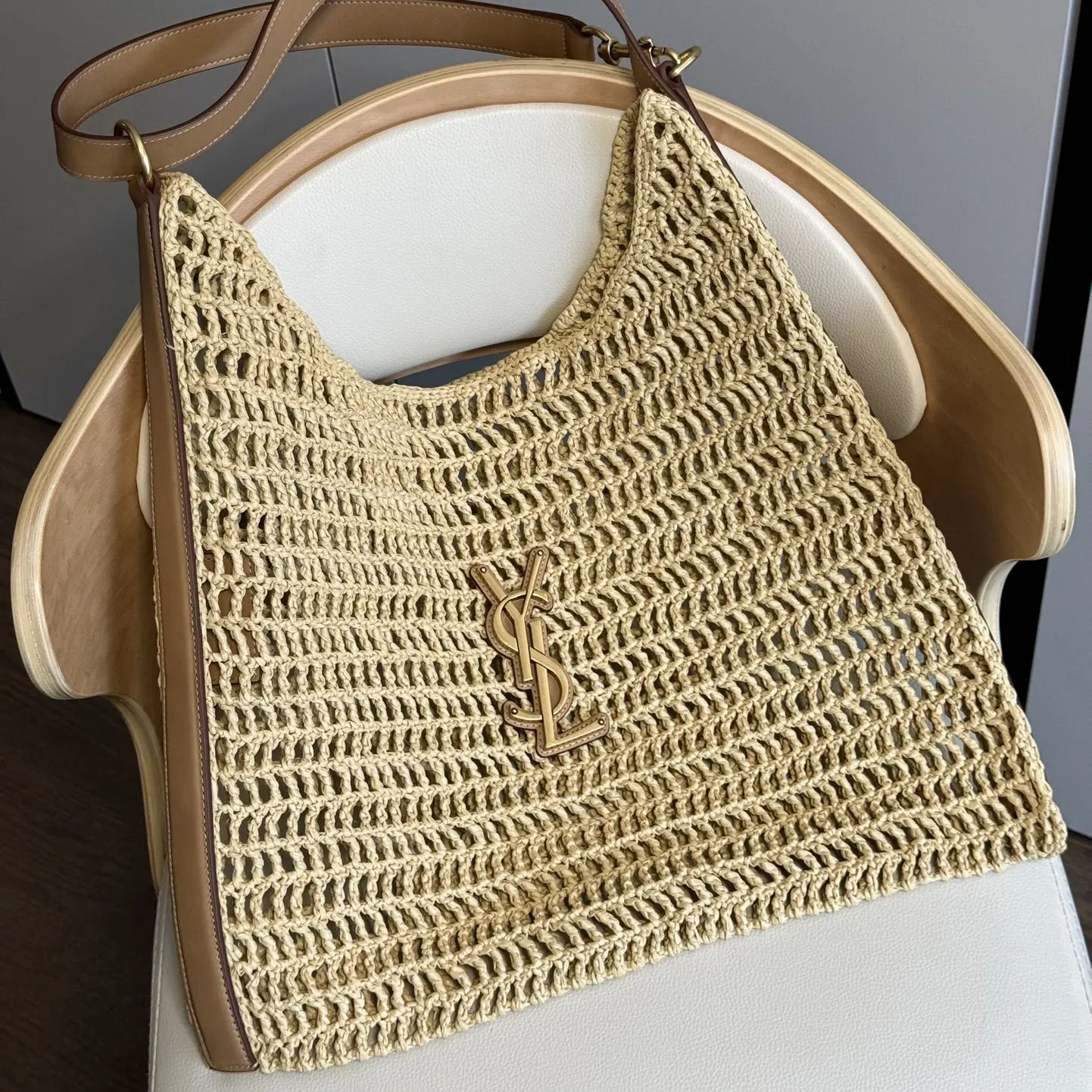 Side angle showing raffia crochet texture and leather strap detail