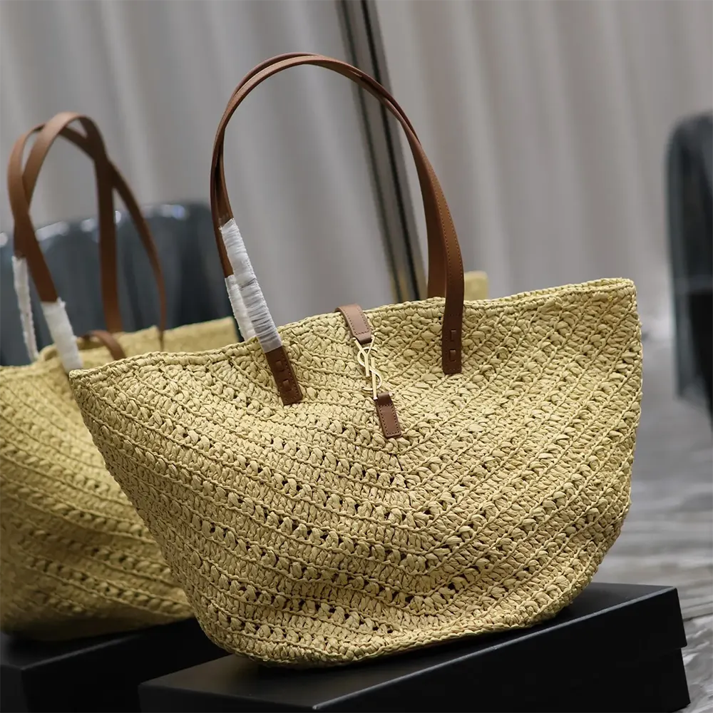 Side angle showing woven raffia texture and leather trim on Saint Laurent Panier Medium