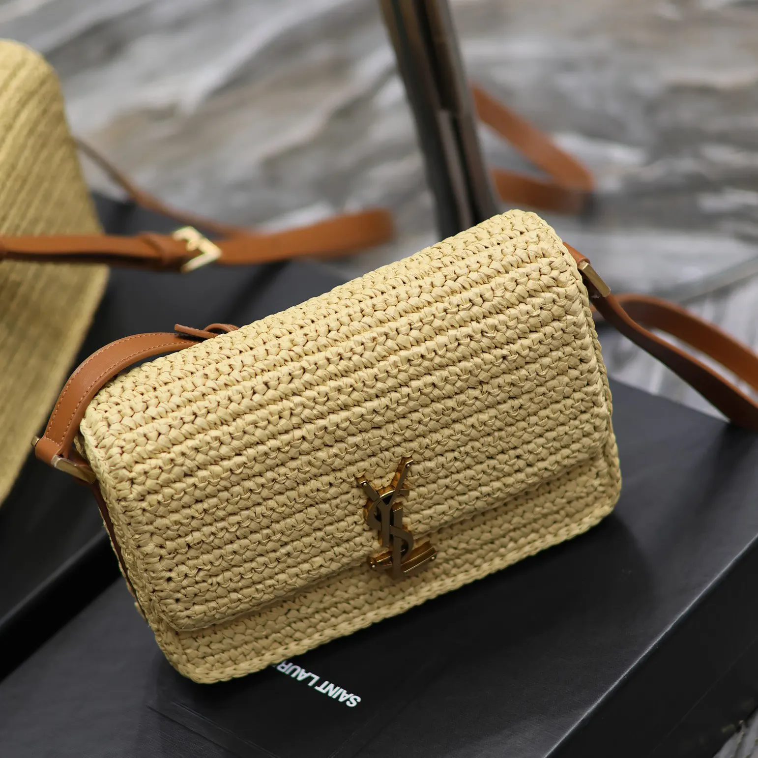 Side angle showing raffia texture and leather trim on Solferino Medium