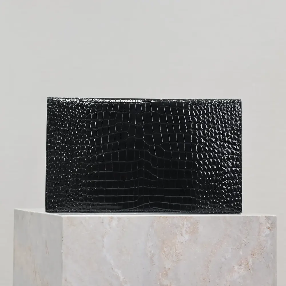 Side angle showing slim silhouette of Saint Laurent YSL Uptown Pouch black leather