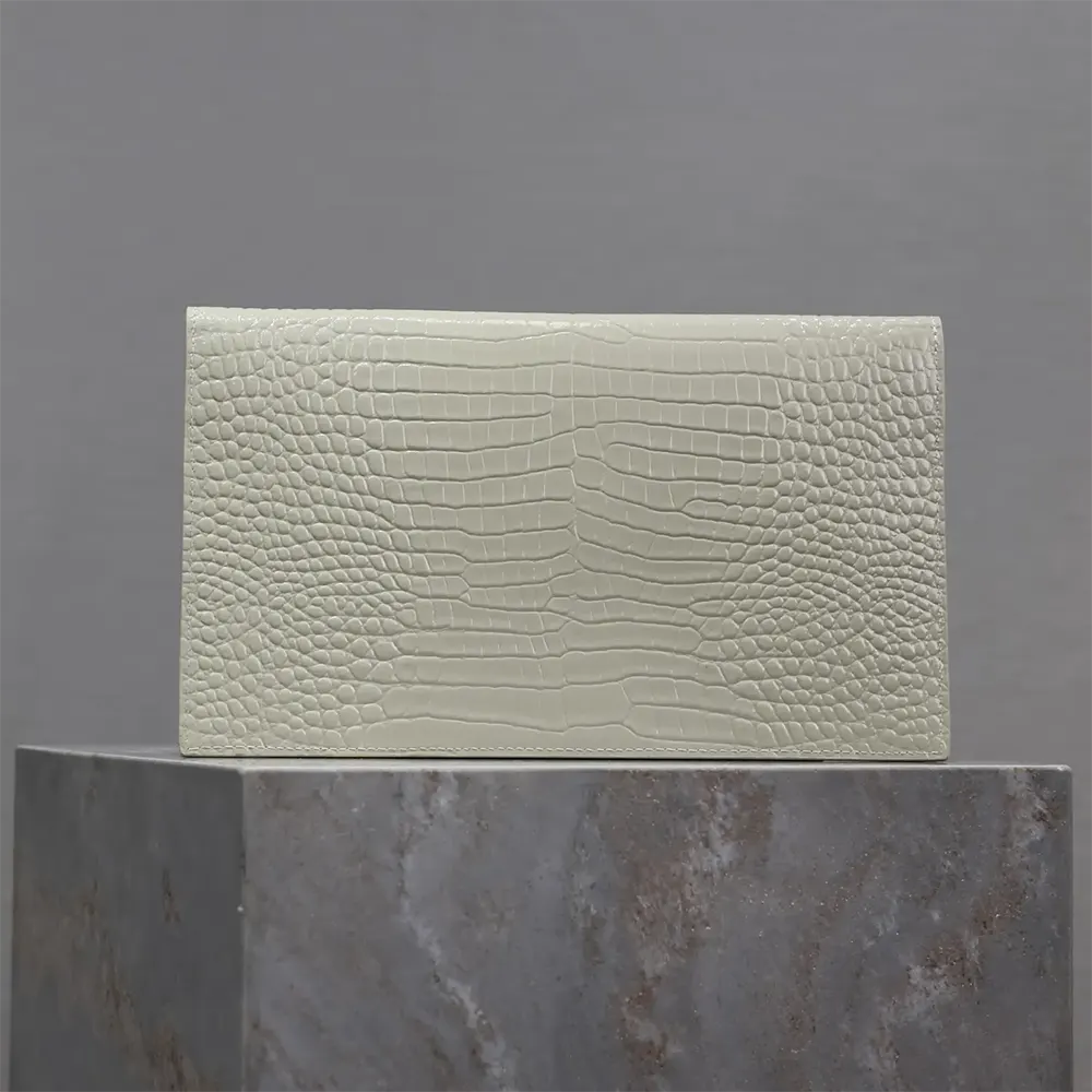 Side view showing silhouette of Saint Laurent YSL white Uptown Pouch