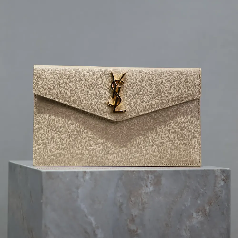 Close-up of gold YSL logo on Uptown Pouch grain de poudre leather