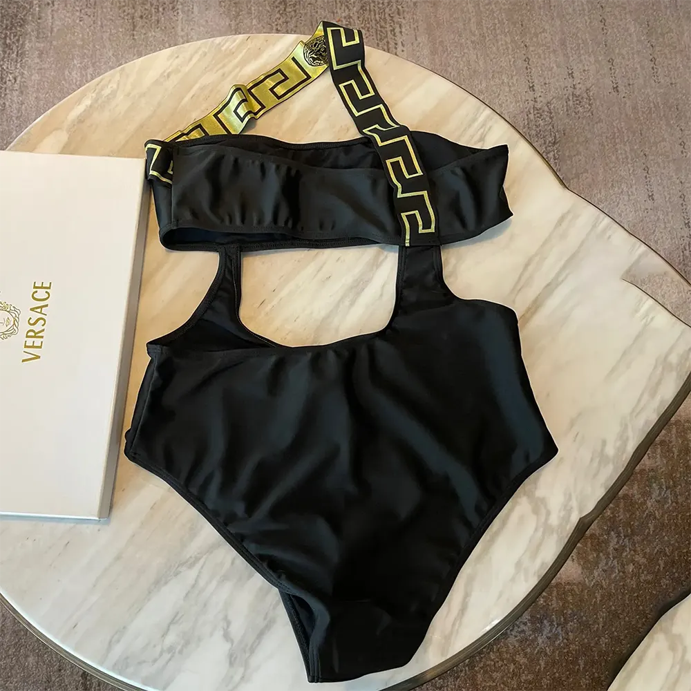 Side angle of Versace Women Greca Border One Piece Swimsuit-Black highlighting fit and silhouette