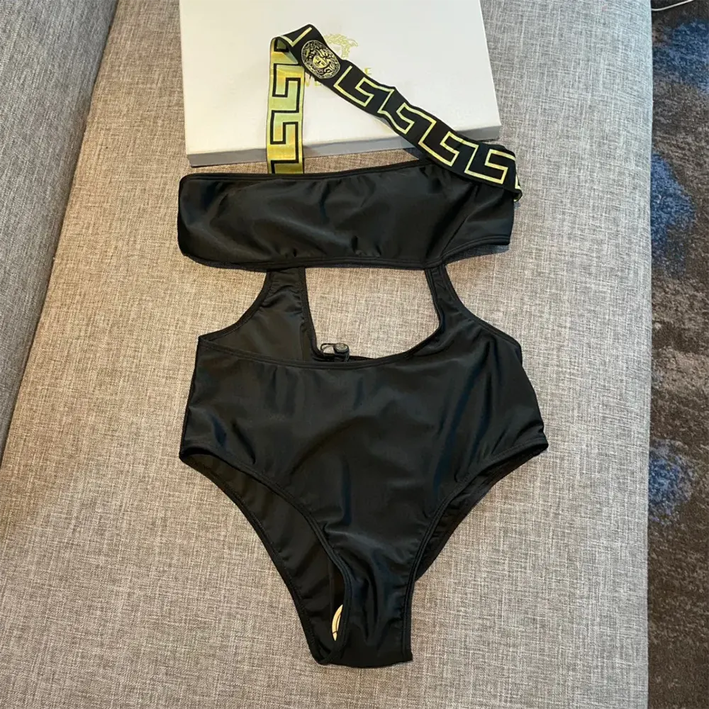 Close-up of gold-toned Greca detailing on Versace Women Greca Border One Piece Swimsuit-Black